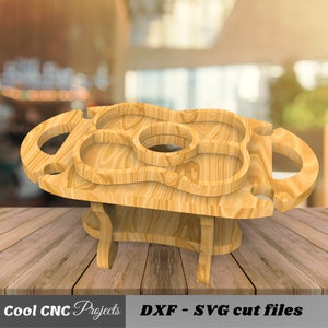 May include: Wooden serving tray with multiple compartments and a bottle holder. The tray is designed to be used as a portable serving station for parties or picnics.  The tray is made of natural wood and has a rustic look.  The tray is shown on a wooden table.