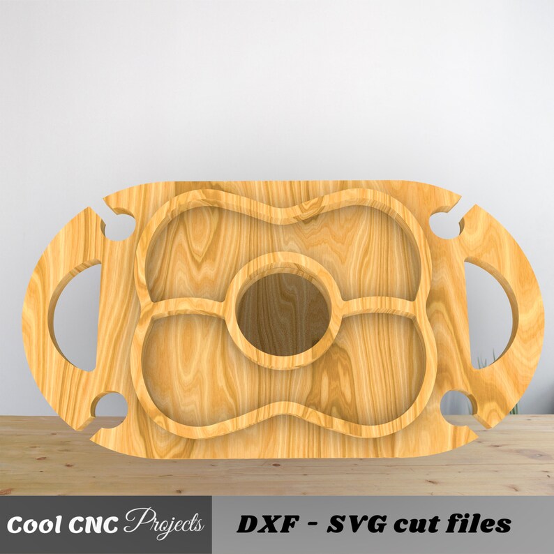 May include: A wooden serving tray with a cutout design for holding snacks and drinks. The tray has two bottle holders on the sides and a large center section with three smaller compartments.  DXF - SVG cut files.
