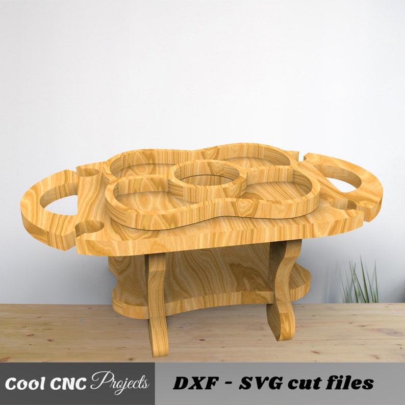 May include: Wooden serving tray with multiple compartments and handles. The tray is on a stand with four legs. The tray is made of light brown wood.  DXF - SVG cut files.