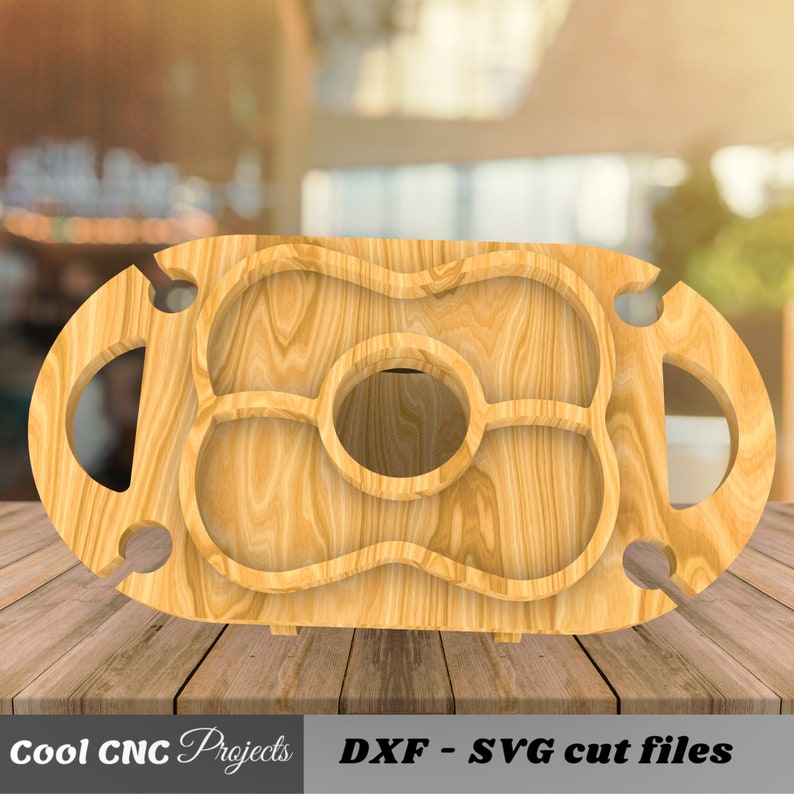 May include: A wooden serving tray with a large center cutout and four smaller cutouts. The tray has two handles on the sides and is designed for serving snacks and drinks.
