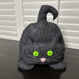 Tope de puerta para gatos