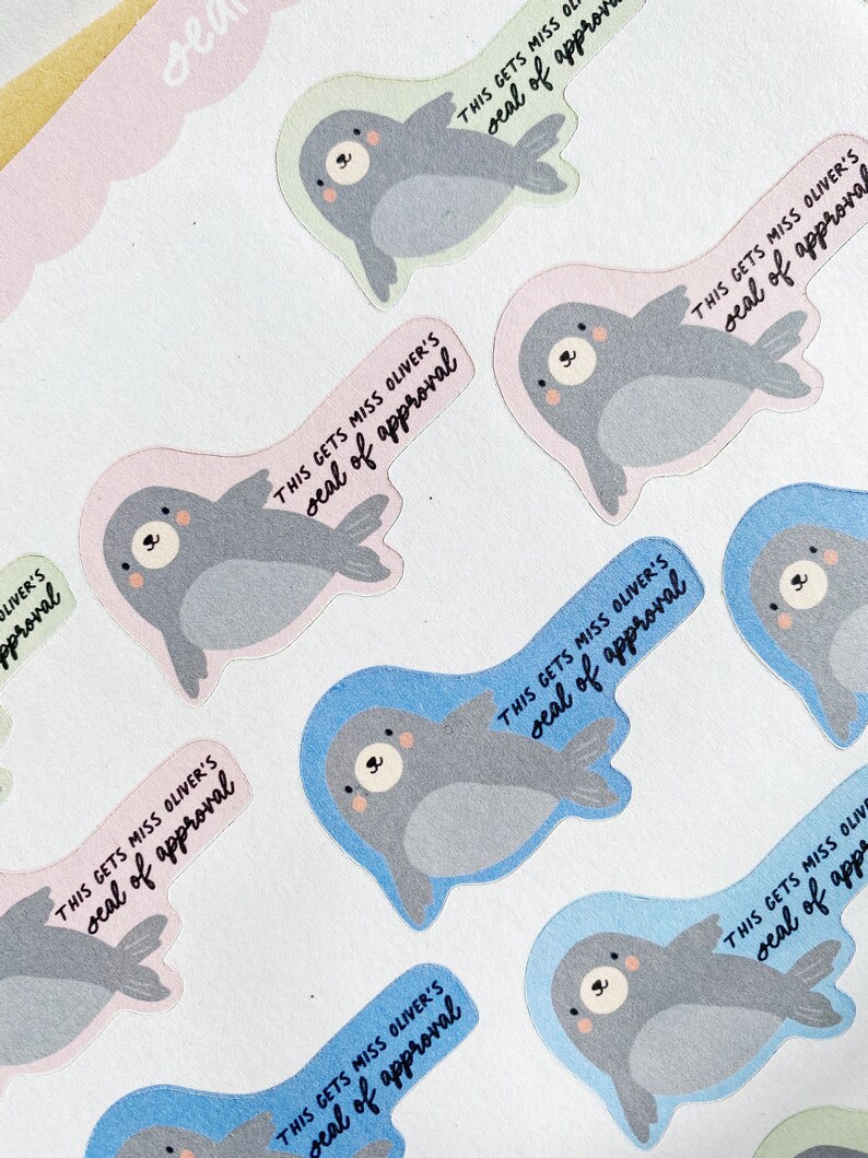 May include: A set of colorful seal stickers with the text "This gets Miss Oliver's seal of approval" on each sticker. The seals are in various poses and have a cute cartoon style.