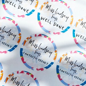 May include: A set of colorful round stickers with the text "Miss Lindsey says" and either "Well Done" or "Fantastic Effort".