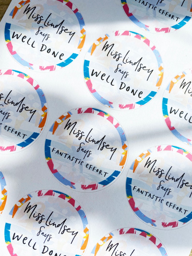 May include: A set of colorful round stickers with the text "Miss Lindsey says" and either "Well Done" or "Fantastic Effort".