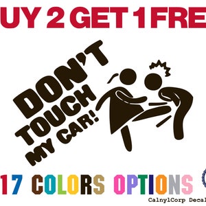 May include: A white decal with the text "BUY 2 GET 1 FREE" in red. The decal features the words "DON'T TOUCH MY CAR!" in black, along with stick figures. It also states "17 COLORS OPTIONS" and "MADE IN USA".