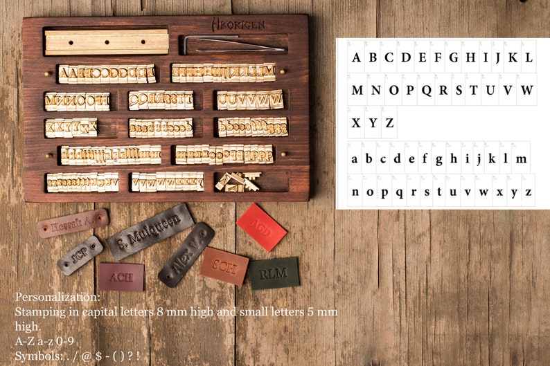 May include: A wooden box with a set of metal letter stamps for stamping leather. The box has a variety of letter stamps, including uppercase and lowercase letters, numbers, and symbols. The box also includes a small tool for pressing the stamps into the leather. The text on the box reads "BORGEN".
