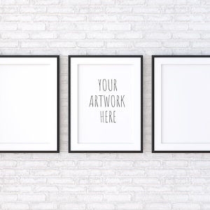May include: Three black picture frames with white mats hanging on a white brick wall. The center frame has the text "YOUR ARTWORK HERE" in black.