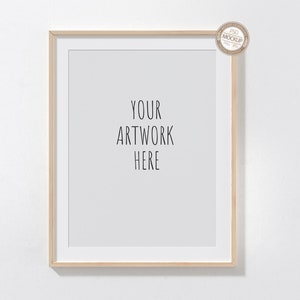 May include: A light wood frame with a white mat and a white background. The text "YOUR ARTWORK HERE" is printed in black on the white background.