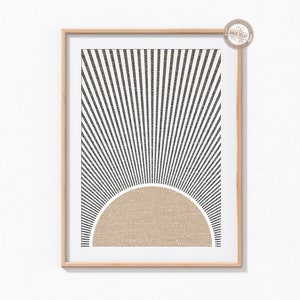 May include: A framed print with a black and white geometric design of radiating lines and a tan half-circle in the center.