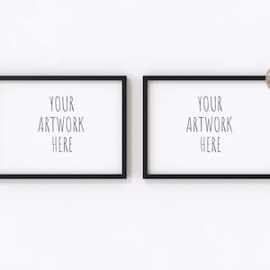 May include: Two black picture frames with white mats hanging on a white wall. The frames are empty and have the text "YOUR ARTWORK HERE" in each frame.
