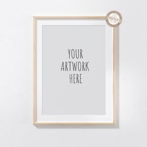 May include: A light wood frame with a white mat and a white background. The text "YOUR ARTWORK HERE" is printed in black on the white background.