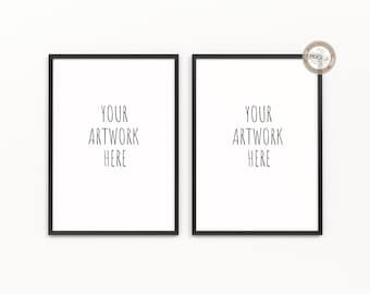 May include: Two black picture frames with white mats and the text "YOUR ARTWORK HERE" in each frame. The frames are hanging on a white wall.