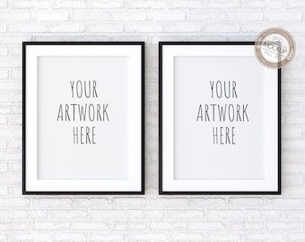 May include: Two black picture frames with white mats hanging on a white brick wall. The text "YOUR ARTWORK HERE" is written in each frame.