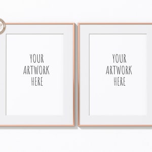 May include: Two empty picture frames with rose gold colored frames and white mats. The text "YOUR ARTWORK HERE" is printed in black on the white mats.