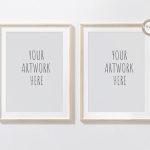 May include: Two wood framed picture frames with white mats and the text "YOUR ARTWORK HERE" in each frame.