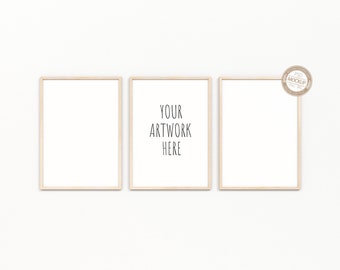 May include: Three wood framed pictures on a white wall. The center picture has the text "YOUR ARTWORK HERE" in black.