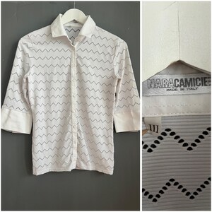 May include: White button-down shirt with a zigzag pattern and three-quarter sleeves. The shirt has a classic collar and cuffs. The tag reads "NARACAMICIE MADE IN ITALY".