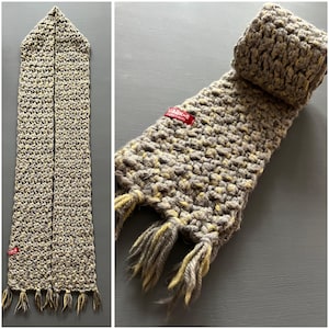May include: A gray and yellow crocheted scarf with fringe. The scarf has a red label that says "Habby's".