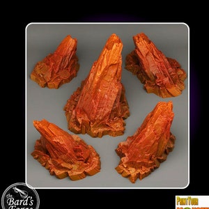 May include: Five orange-brown rocky terrain pieces for tabletop gaming. The pieces are various sizes and shapes, with jagged edges and a rough texture. They are ideal for creating a rocky landscape or mountain range on a tabletop.