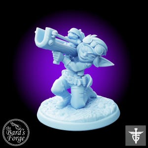 May include: A light blue plastic miniature figurine of a goblin wearing goggles and holding a large weapon. The goblin is kneeling on a round base with a textured surface.