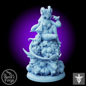 May include: A blue miniature figurine of a female figure with horns and a long tail, sitting on a pile of skulls. The figure is wearing a long, flowing robe and has a stern expression on her face.