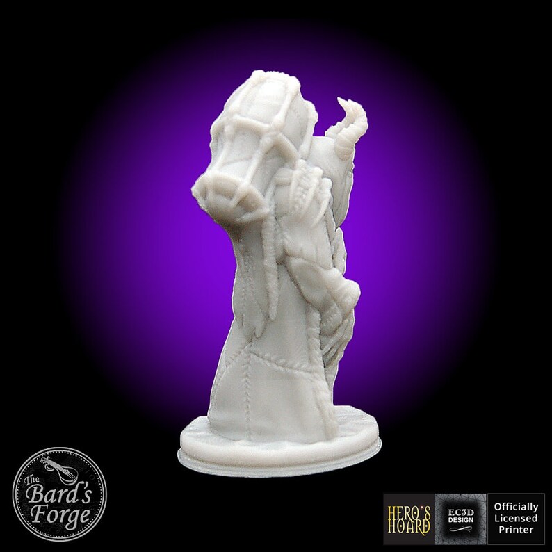 May include: A white 3D printed miniature of a creature with a stitched-together body, holding a large sack of coins. The miniature is standing on a round base. The text "Hero's Hoard" is visible on the base.