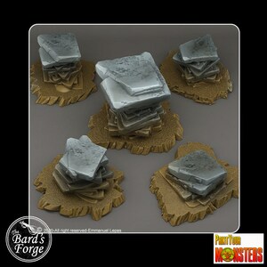 May include: Five miniature stone bases for tabletop gaming. Each base is made of stacked, irregularly shaped, gray stones. The bases are set on a brown, textured surface.