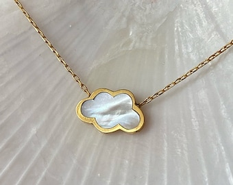 May include: A gold-toned chain necklace featuring a central cloud-shaped pendant. The pendant has a smooth gold-colored metal border and is inlaid with a shimmering, iridescent white mother-of-pearl material that reflects light.