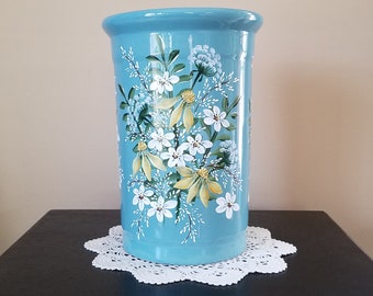 Blue ceramic vase.  Very heavy.  Hand painted. White and yellow garden flowers.