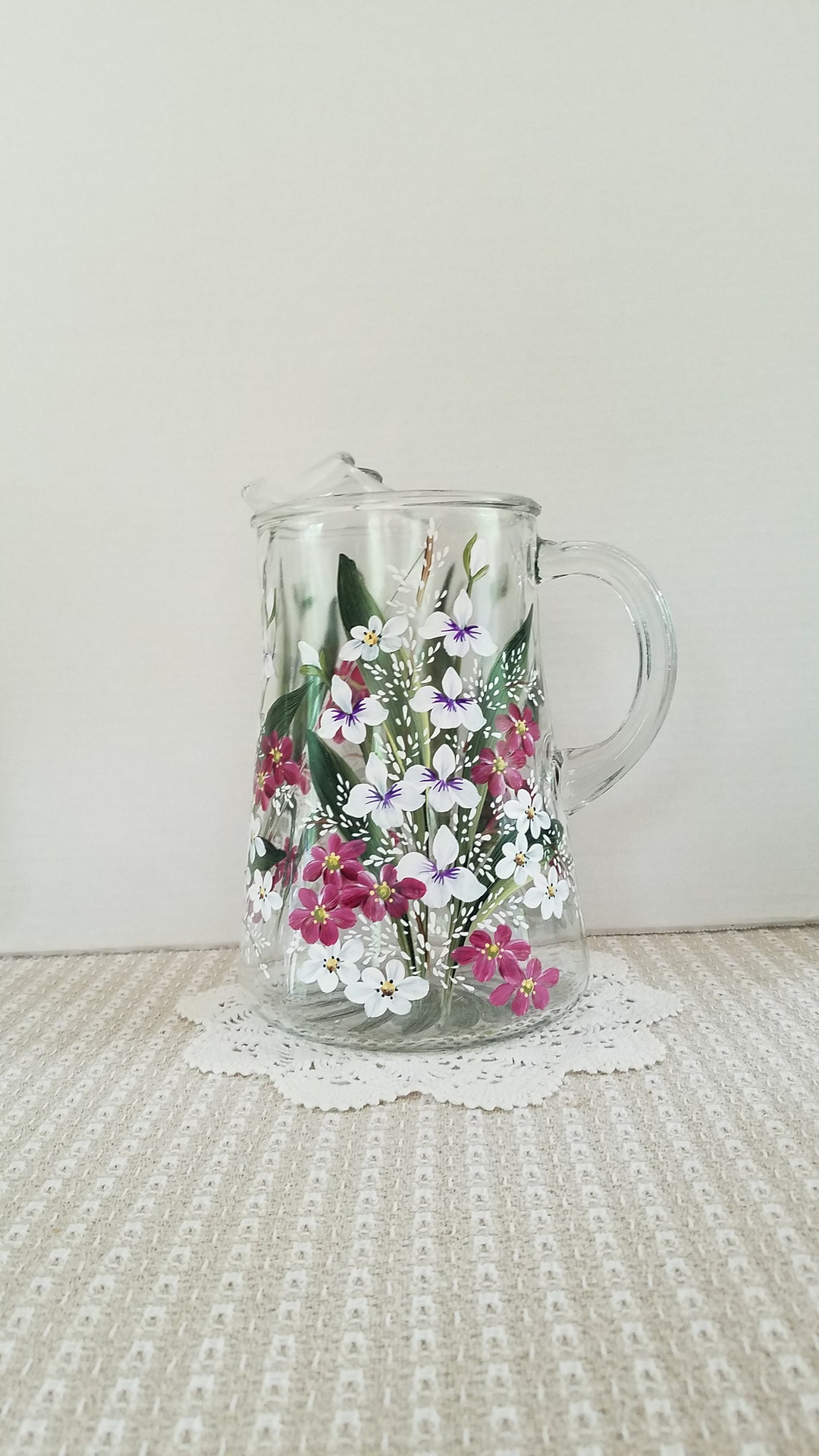 Large glass beverage pitcher.  White and berry wine garden flowers.  Hand painted.