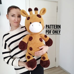May include: A large, soft toy giraffe in tan and brown. The giraffe has dark brown spots, ears, and hooves. The text "PATTERN PDF ONLY" is visible on the right side of the image. The toy is designed to be soft and cuddly, suitable for children.