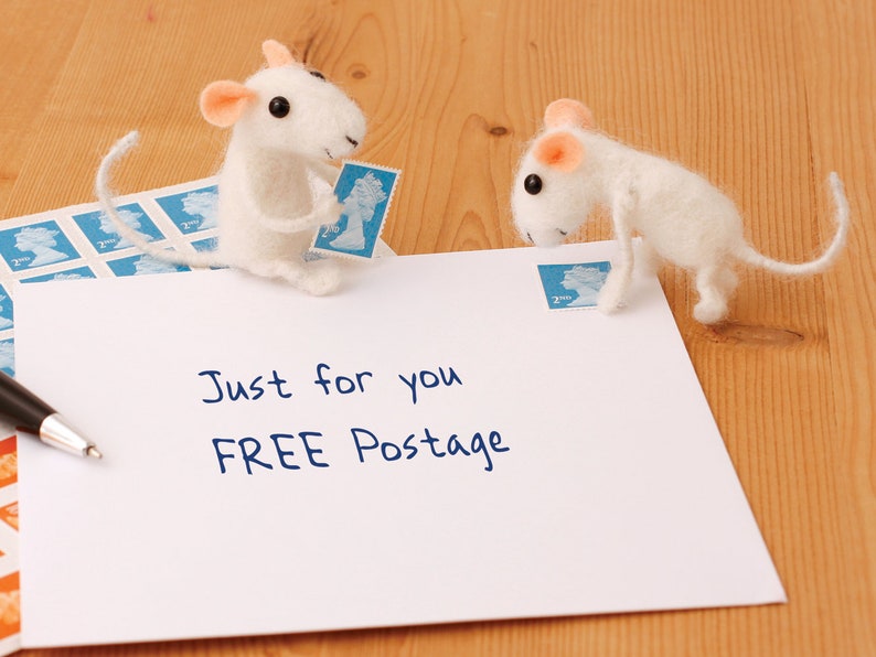 May include: A white envelope with the text "Just for you FREE Postage" written on it. Two white felt mice are on the envelope, one holding a blue stamp and the other looking at the stamp.