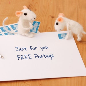 May include: Two white felt mice holding postage stamps on a white envelope with the text "Just for you FREE Postage".