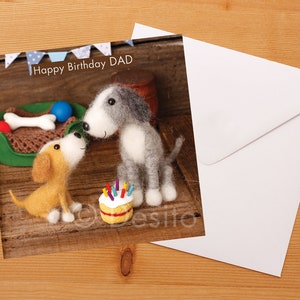 May include: A birthday card featuring two felt dogs, one gray and one brown, with a birthday cake and the text "Happy Birthday DAD".