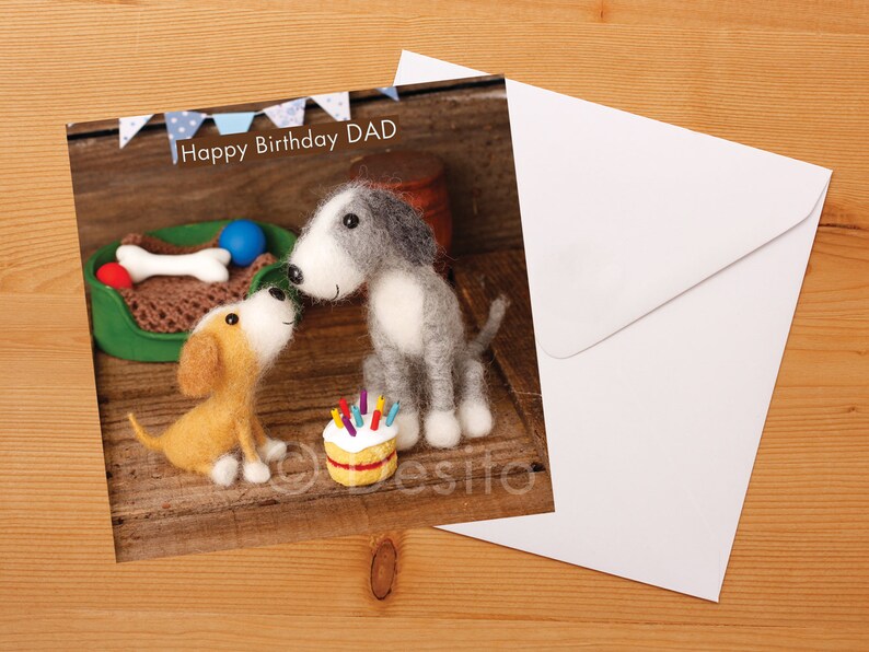 May include: A birthday card featuring two felt dogs, one gray and one brown, with a birthday cake and the text "Happy Birthday DAD".