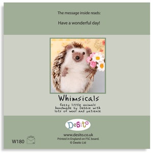 May include: A handmade felt hedgehog holding a bouquet of pink and white flowers. The card reads "Whimsicals fuzzy little animals handmade by Debbie with lots of wool and patience Desito www.desito.co.uk Printed in England on FSC board. Desito Ltd."