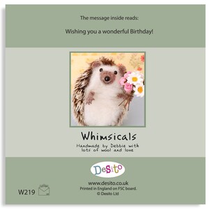 May include: A handmade felt hedgehog holding a bouquet of pink and white flowers. The card reads "Whimsicals Handmade by Debbie with lots of wool and love" and "DeSito www.desito.co.uk Printed in England on FSC board. &copy; Desito Ltd."