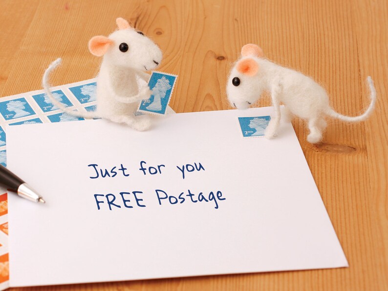 May include: A white envelope with the text "Just for you FREE Postage" written on it. Two white felt mice are on the envelope, one holding a blue stamp and the other looking at the stamp.