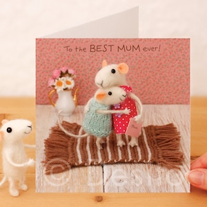 May include: A greeting card with a felt mouse illustration. The card features two mice hugging and the text "To the BEST MUM ever!"