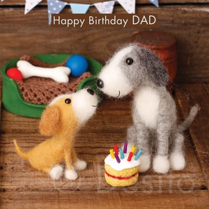 May include: A birthday card featuring two felt dogs, one gray and white and one brown and white, with a small cake with candles. The card reads "Happy Birthday DAD".