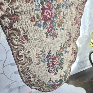 May include: A white ceramic mug with a black handle and the text "But First, Coffee" in a black, bold font. The mug is on a white surface.