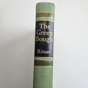 May include: A light green book spine with a central black panel featuring the gold-coloured text The Green Bough and the author name Ritner. The spine includes horizontal gold-coloured decorative lines above and below the black panel area.