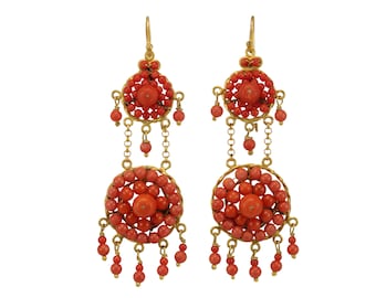 May include: A pair of gold earrings with two tiers of coral beads. The top tier is a round cluster of coral beads, and the bottom tier is a larger round cluster of coral beads. The earrings are suspended from a gold hook.