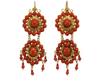 May include: A pair of gold earrings with red coral beads and a large coral cabochon in the center of each earring.