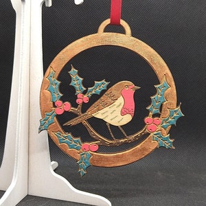Robin in amongst holly, hand-drawn & hand painted, laser-etched, and cut out of plywood,