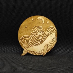 Whale and the moon, hand-drawn, laser-etched and laser-cut into wood