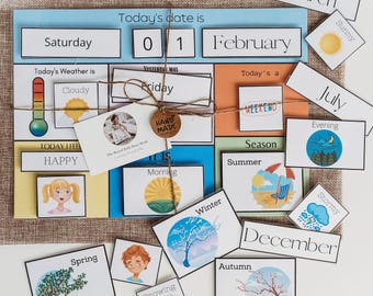 May include: A colorful felt board with various cards and labels for teaching days of the week, months, weather, seasons, and more. The board includes the words "Saturday", "Today's date is", "01", "February", "Today's Weather is", "Cloudy", "YESTERDAY WAS", "Friday", "Today's a", "WEEKEND", "Season", "Summer", "Winter", "December", "Autumn", "Spring", "March", "Sunny", "July", "Evening", "Stormy", "HAPPY", "IT IS", "Morning", "Snowing".
