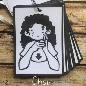 May include: Black and white illustration of a person signing the word "chair" in American Sign Language. The image is labeled "Chair" and "Digital Download Only".