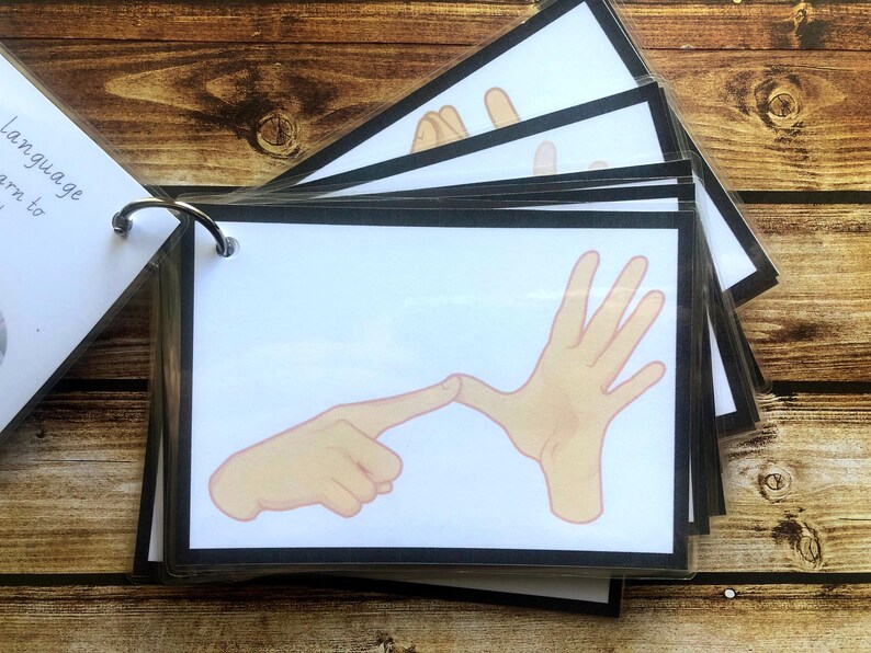 May include: A set of flashcards with black borders and white backgrounds. Each card features a different hand sign, with the text "Language to learn" on the cover.