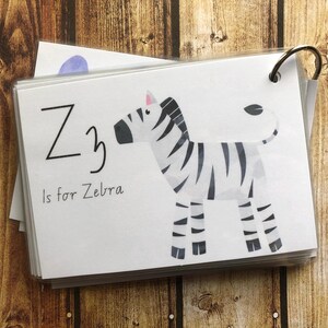 May include: A white card with black text and a black and white zebra illustration. The text reads "Z is for Zebra".
